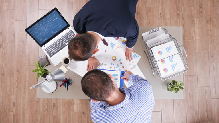 Top view of businessmen working at company strategy analyzing management paperwork